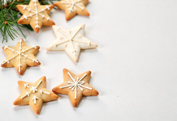 Assorted Christmas sugar cookies decorated with colorful icing, including star shapes, on a white background
