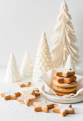 Assorted Christmas sugar cookies decorated with colorful icing, including star shapes, on a white background