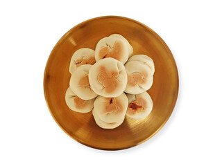 Pile of Bakpia Pathuk served on a golden plate isolated on white background. Top View. Chinese-influenced Indonesian traditional snacks stuffed with mung beans. Food souvenir of Yogyakarta.