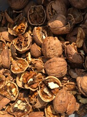 A close-up shot of cracked walnut shells and kernels, highlights the textures and natural beauty of this nutritious snack. The image showcases fresh walnuts