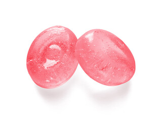 Two pink fruit hard candies isolated on white background. Strawberry flavor crystal candy close up...