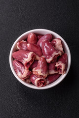 Raw chicken hearts with salt, spices and herbs