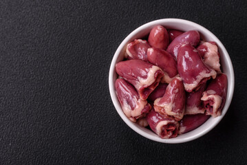 Raw chicken hearts with salt, spices and herbs