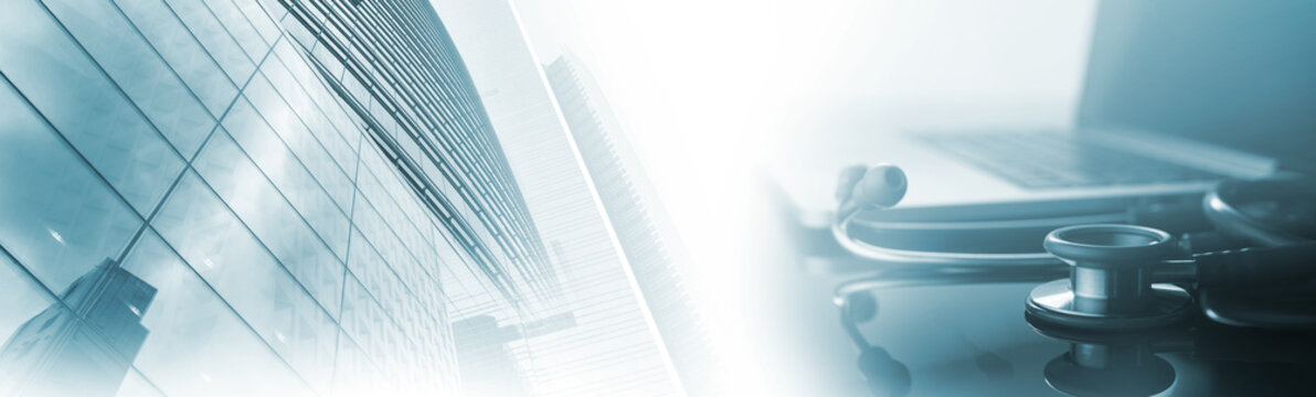 Medical background. Stethoscope and laptop computer with modern hospital buildings and copy space for text, medical business web banner, health service, medical online