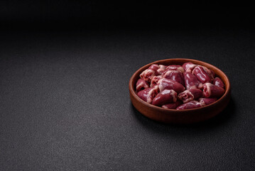 Raw chicken hearts with salt, spices and herbs
