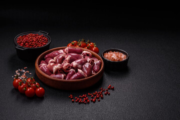 Raw chicken hearts with salt, spices and herbs