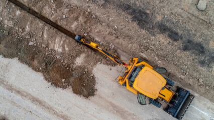 small construction equipment digging ditch