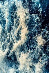 Fototapeta premium A Close-up of White Ocean Foam Against a Dark Blue Water Surface