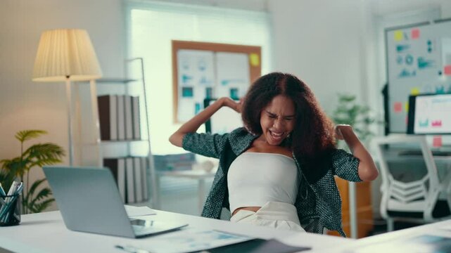 Young african american businesswoman is reacting badly to her work on her laptop, going from focused to very angry and stressed