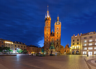 St. Mary's Basilica in Krakow, Poland, before dawn in the Main Market Square. The illuminated twin...