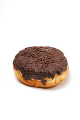 A whole donut without a hole, topped with hardened chocolate glaze and generously covered in chocolate sprinkles. Photographed on a white background.