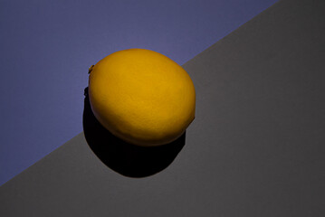 lemon on lilac and grey background