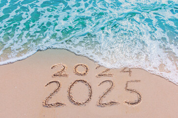 Message Year 2024 replaced by 2025 text written on beach sand background. Good bye 2024 - 2025...