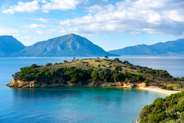 Wild beach on an islet in Greece on a summer day with mountains
