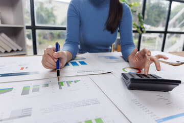 Business financing accounting banking concept. Business woman hand doing finances and calculate on desk about cost at home office. Woman working on desk with using calculator, finance accounting.
