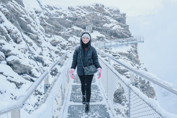Grindelwald first, Switzerland Woman on First Cliff Walk viewing platform on the First mountain in...