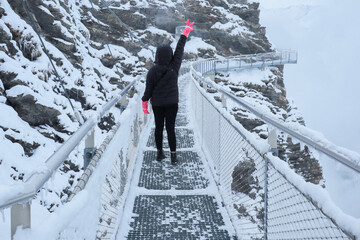 Grindelwald first, Switzerland Woman on First Cliff Walk viewing platform on the First mountain in...