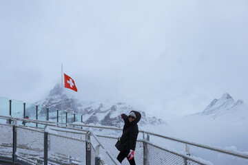 Grindelwald first, Switzerland Woman on First Cliff Walk viewing platform on the First mountain in...
