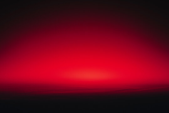 Abstract gradient with a glowing red horizon fading into deep black, creating a minimalist and dramatic background