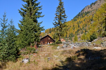 Majestic peaks rise above golden valleys, as crisp autumn air sweeps through the serene alpine landscape near Sölden in Tyrol, Austria