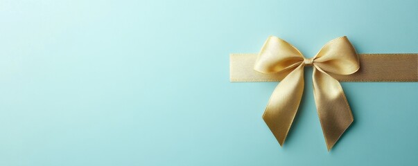 Gold Bow on Turquoise Background with Space for Text