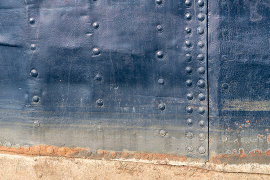riveted hull of an old ship for background use