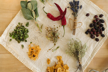 Top view of dried herbs and seasonings on linen tablecloth. Healthy homemade and natural. Red hot pepper. 