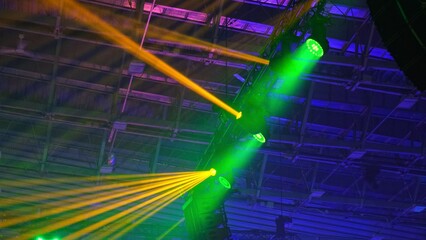 High Luminance Stage Disco Lights Casting Colorful Light Beams during Concert Gig Performance in...