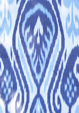 traditional blue and white Ikat adras pattern with intricate symmetrical designs used in Uzbek textiles, eastern background