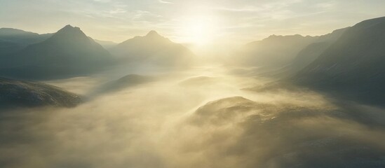 Obraz premium Sunrise Over Misty Mountain Peaks