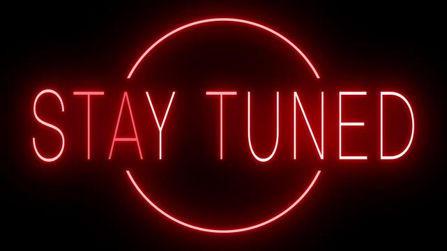 Flickering red retro style neon sign glowing against a black background STAY TUNED