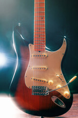 Sunburst electric blues guitar on wooden floor. Gently toned.