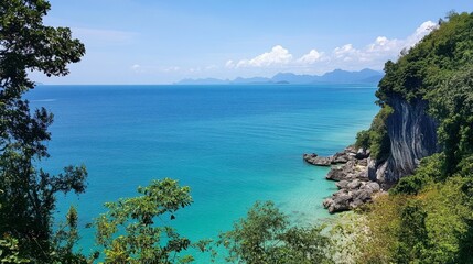 A breathtaking view of the Andaman Sea from a cliffside viewpoint in Satun, with clear blue waters stretching to the horizon.