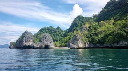 Obraz premium A captivating view of the limestone karsts rising from the sea at Koh Tarutao, creating a dramatic backdrop for visitors.