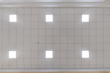 cassette stretched or suspended ceiling with square halogen spots lamps and drywall construction in...