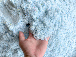 Hands are holding microplastic fragments or small pieces of plastic. that can be filtered from water sources