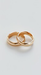 Pair of gold wedding rings, white background, 4K hyperrealistic photo