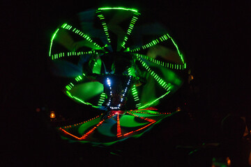 Performance of a young artist, evening light show on the Safaga stage, Egypt July 2022, Long exposure time. Dervish Dance
