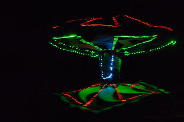 Performance of a young artist, evening light show on the Safaga stage, Egypt July 2022, Long exposure time. Dervish Dance