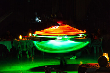 Performance of a young artist, evening light show on the Safaga stage, Egypt July 2022, Long exposure time. Dervish Dance