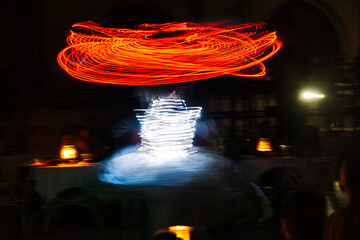 Performance of a young artist, evening light show on the Safaga stage, Egypt July 2022, Long exposure time. Dervish Dance