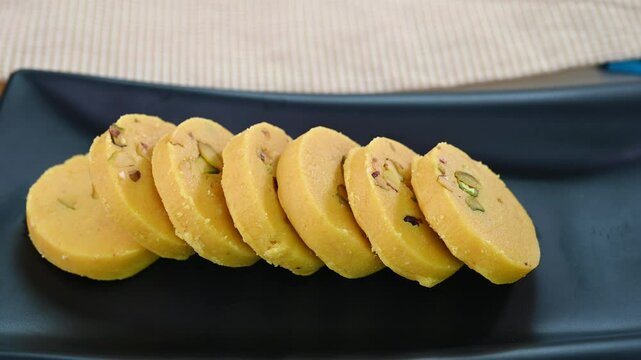 Serving kesar peda indian sweet in a plate.
