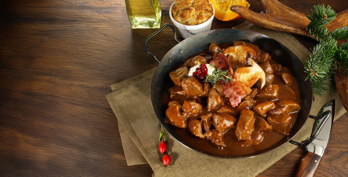 Venison Goulash - Deer Stew with Mushrooms in a Pot with Bacon