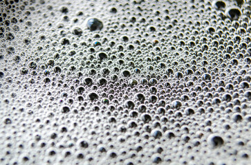 Top view of tiny bubbles on dark background. Suitable for wallpaper or design