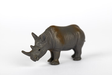 Obraz premium Grey plastic toy rhinoceros isolated on white background. Concept of mammal animals