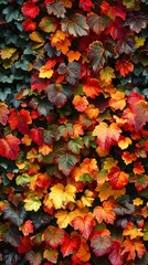 Dense wall of tiny leaves in autumn hues, vibrant colors, soft lighting, capturing the warmth of the season.