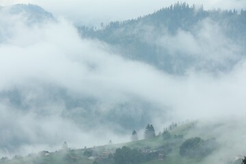 Picturesque view of beautiful mountains covered with fog