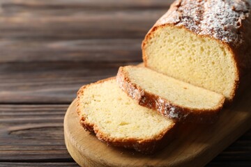 Freshly baked sponge cake on wooden table, closeup