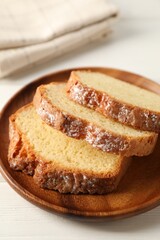 Freshly baked sponge cake on white wooden table, closeup