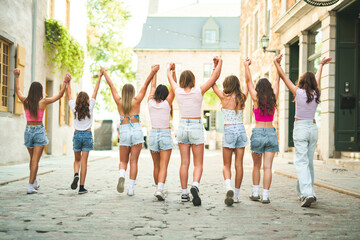 Happy teenagers or childs having fun together on city background